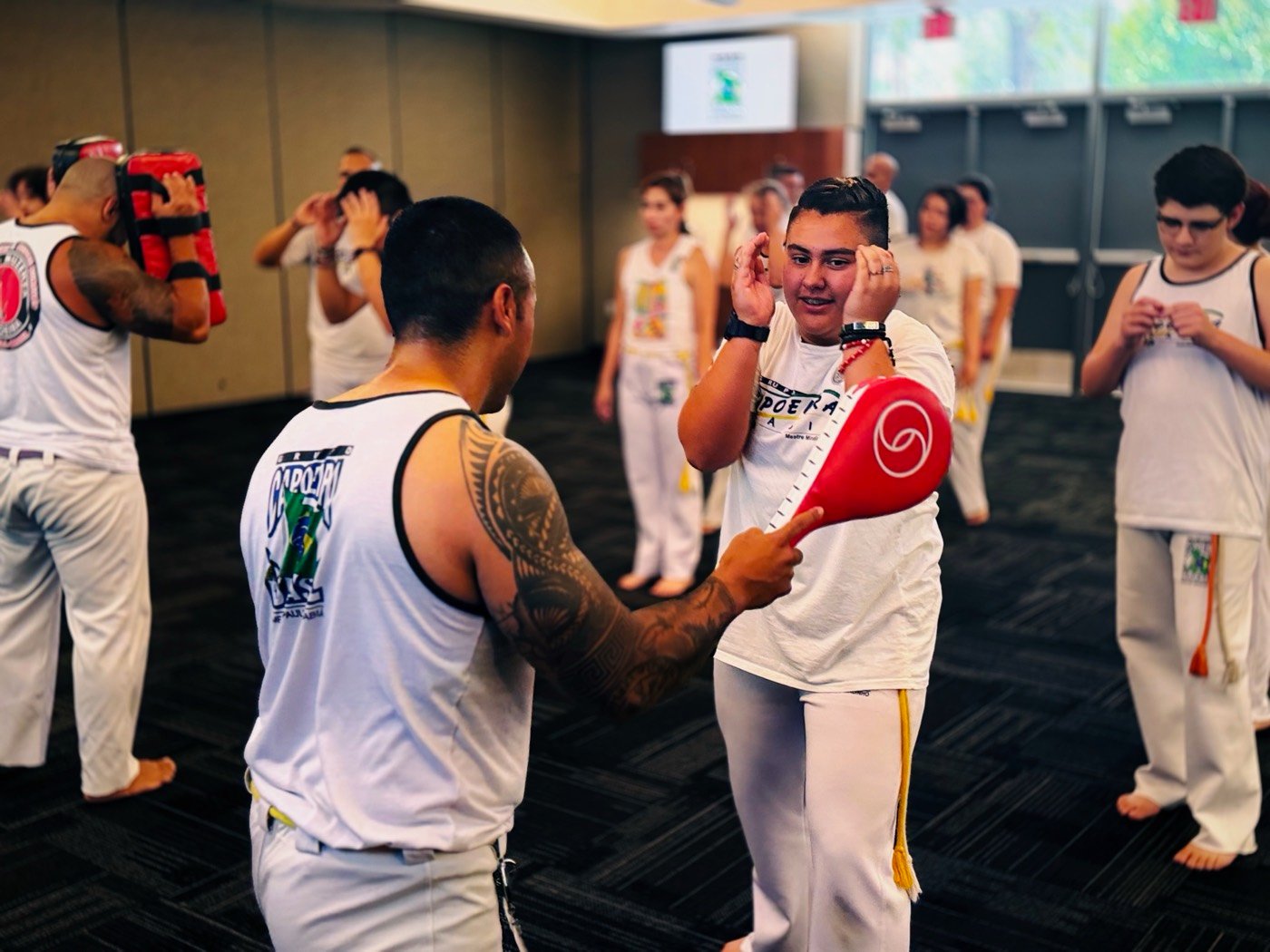 Students training with pads in class